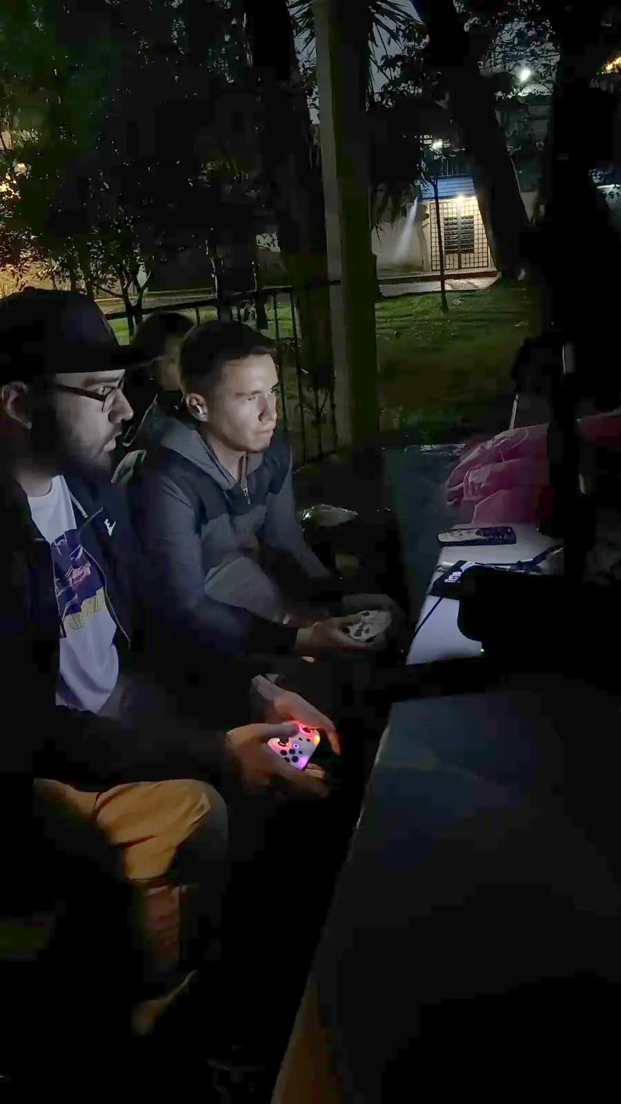 Jugadores con controles durante una reta nocturna al aire libre